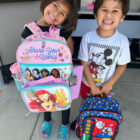 Students receive back to school backpacks and supplies.