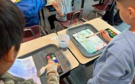 Students watercolor painting.