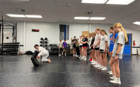 Students observing a martial arts demonstration in class.