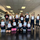 Students with their certificate of achievements.