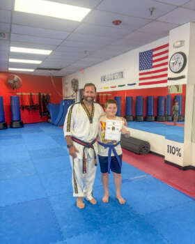 S.M. Smith with student at a Youth Martial Arts Program camp in Ohio